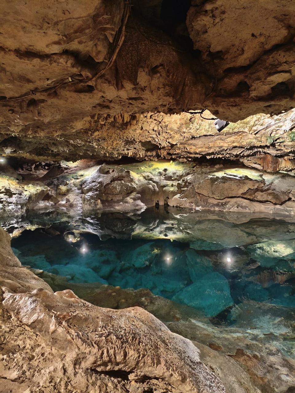 Agua cristalina bajo las formaciones de roca del Cenote San Ignacio
